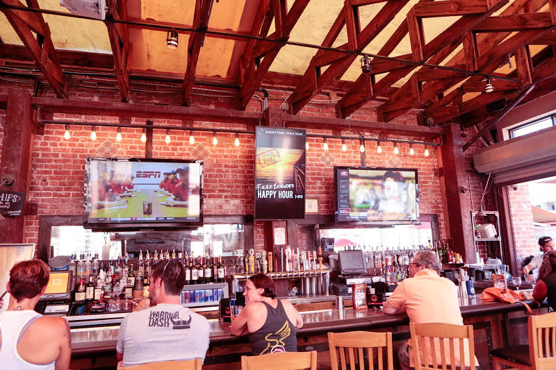 digital signage promoting happy hour in bar